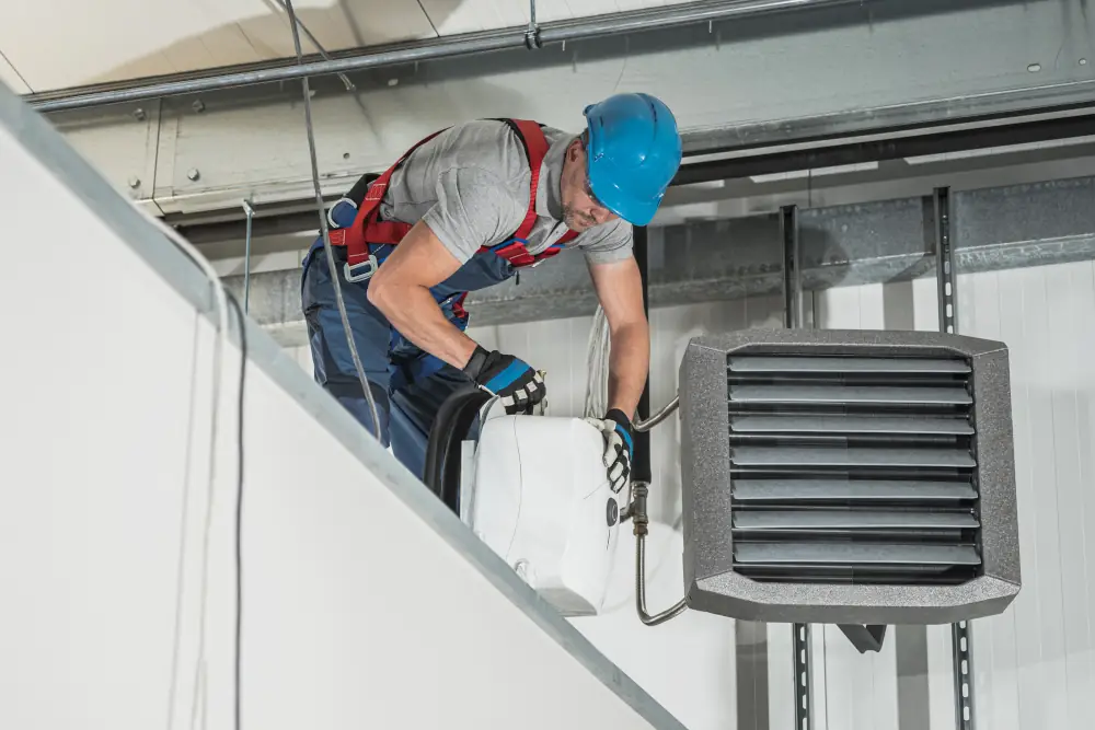 Exploring Garage Heater Benefits & Drawbacks For Calgary Residents - HVAC technician installing a garage heater