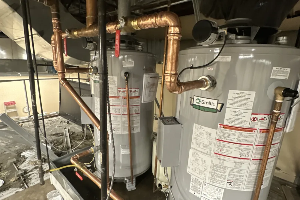 Most common spring plumbing repairs for commercial and residential settings! - Picture of plumbing leading to water heaters