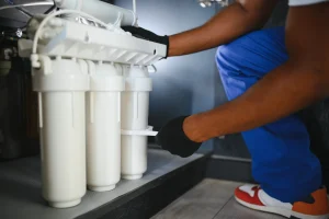 Plumber installs or change water filter. Replacement aqua filter